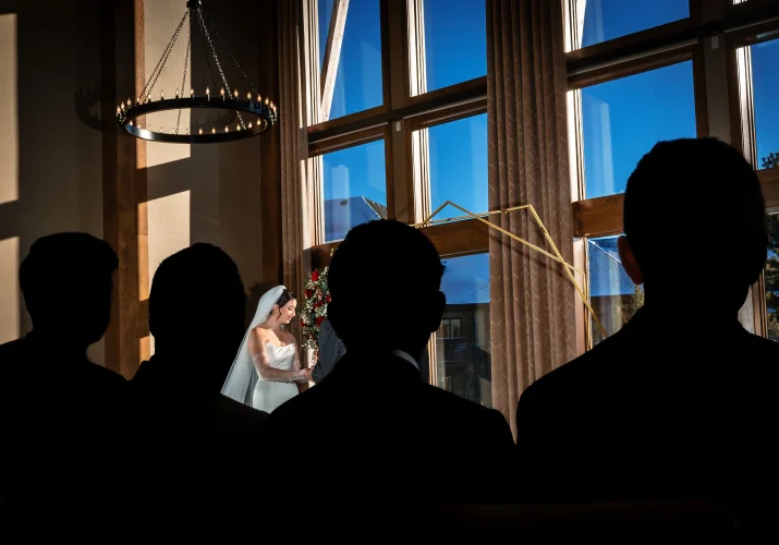 Canmore Wedding Photography of the bride and silhouetted guests looking at her.