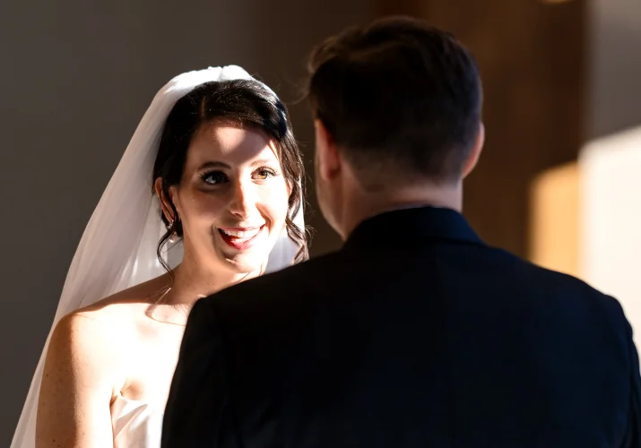 Bride looks with love on the groom