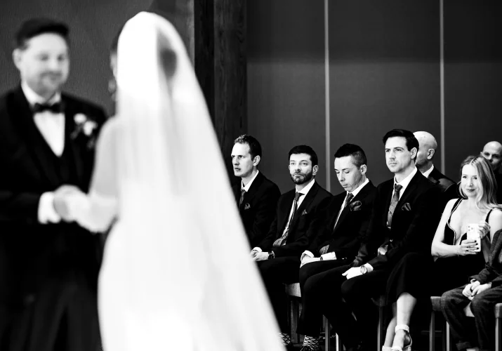 Groomsmen looking at the newlyweds on the wedding ceremony in Canmore.
