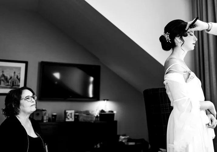 Mather looks at the bride wearing a wedding dress in Canmore