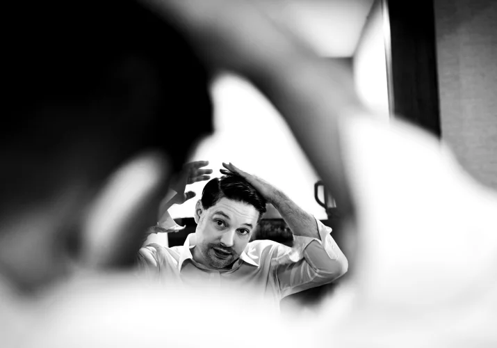 Groom brushes his hair before wedding in canmore