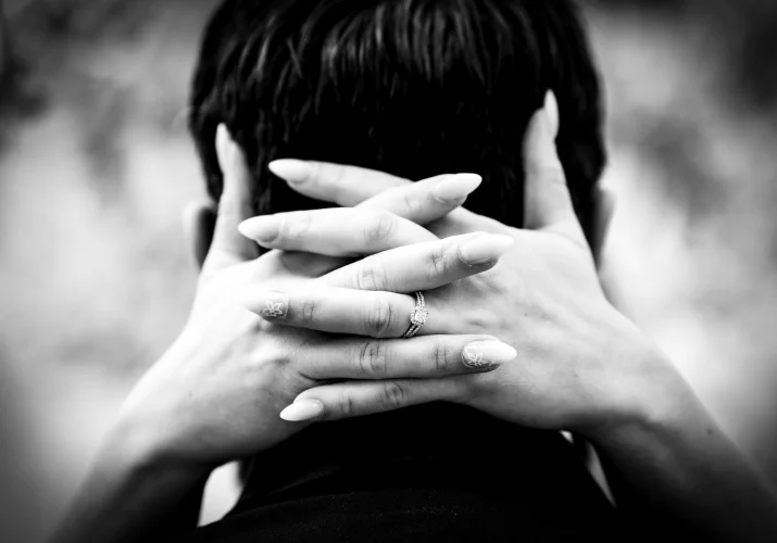 bride's hands on the grooms neck