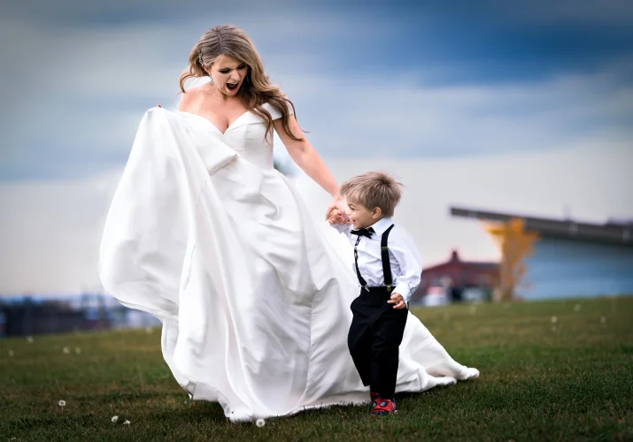 gorgeous bride runs with her son at the Edmonton Wedding