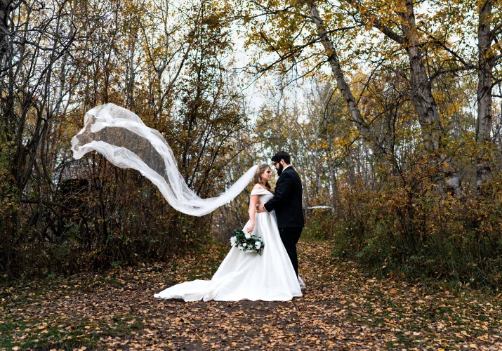Incredible portrait of the bride and groom with flying veil in the park in Edmonton.