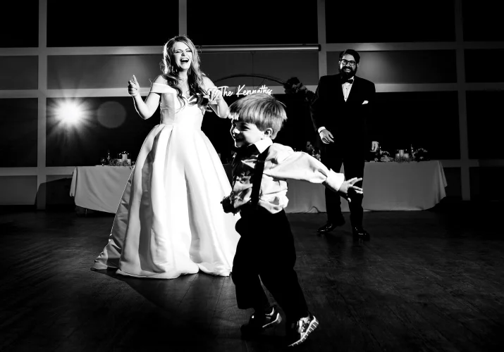 Bride, groom and their little son dance at the dance-floor in Edmonton