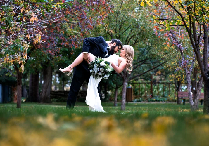 Edmonton Wedding Portrait of the groom kissing the bride in the park.