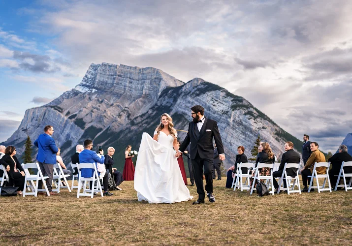 Bride and groom walkin down the aisle in Banff