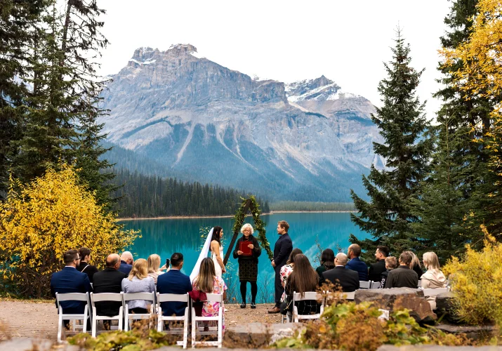 Beautiful fall wedding ceremony against the mountains and lake in Banff National Park.