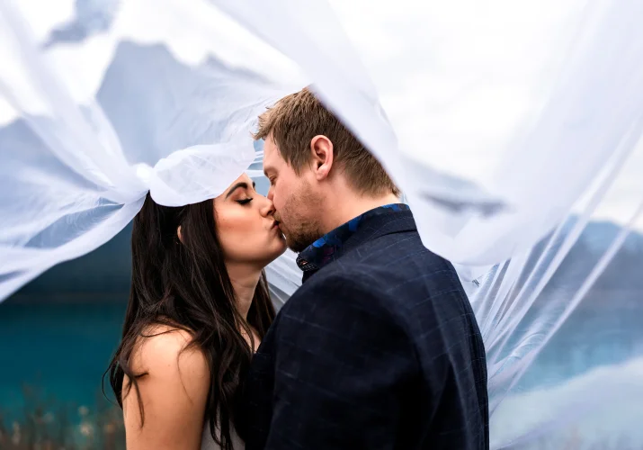 Bride and groom share a kiss under the veil