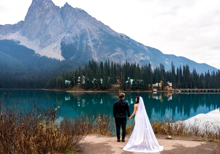 Banff Wedding Photography at Emerald Lake of the bride and groom looking at the mountains.