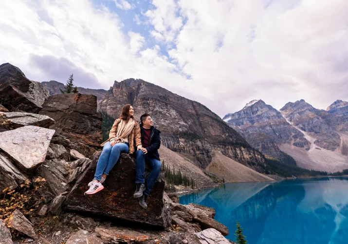 young couple in love cooking at the sky in the Canadian rockies