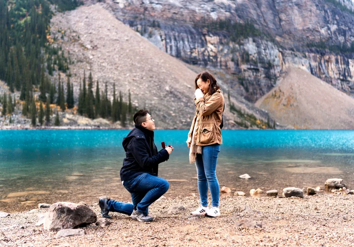 met goes down the knee at Moraine Lake and asks his girlfriend to marry him