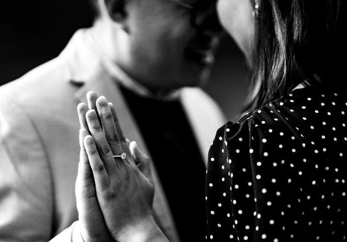 engaged coupe head to head touching hands.