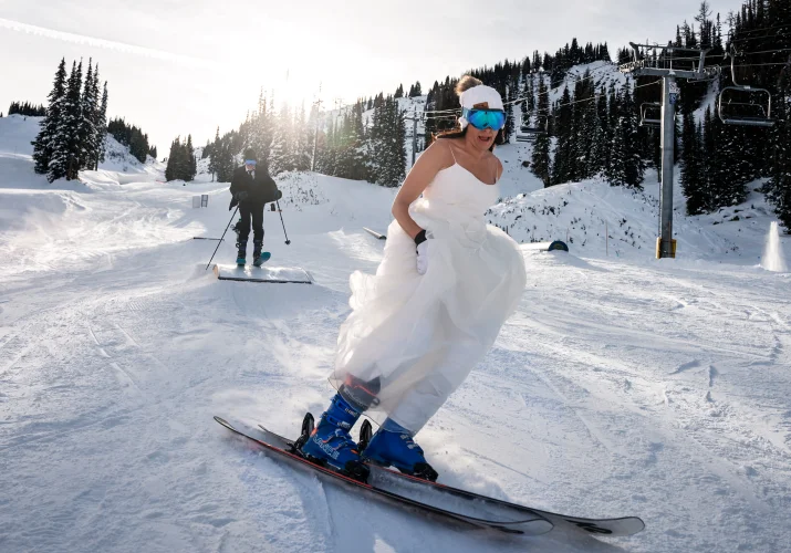 Bride wearing wedding dress and skiing in Banff.