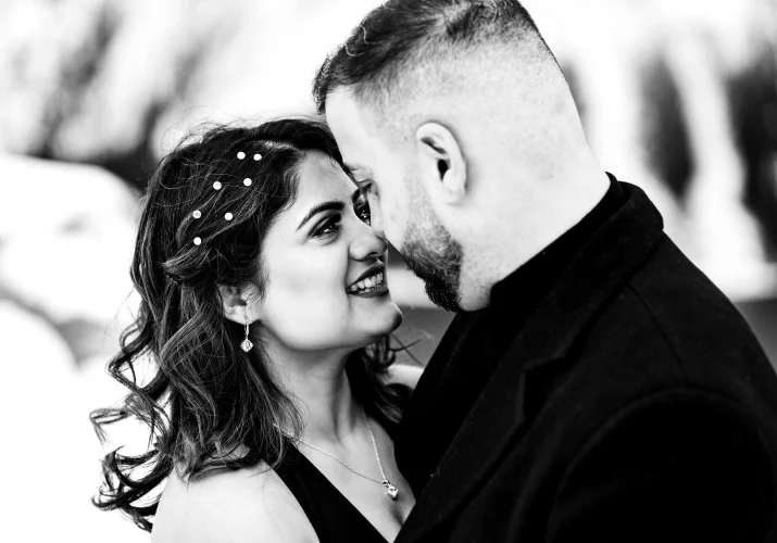 intimate moment of engaged couple touching their noses and looking at each others eyea.