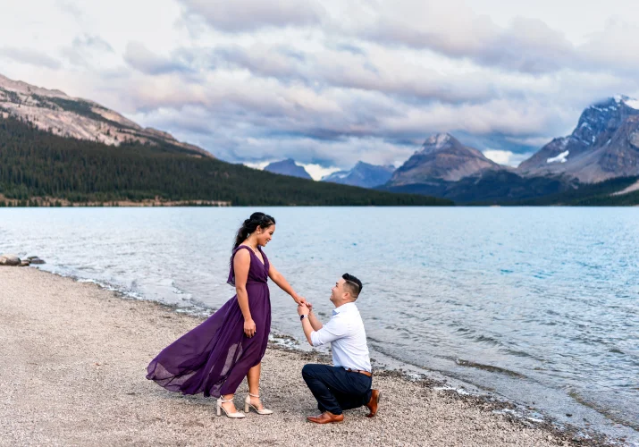 Man goes down on a knee and propose at Bow Lake in Alberta.