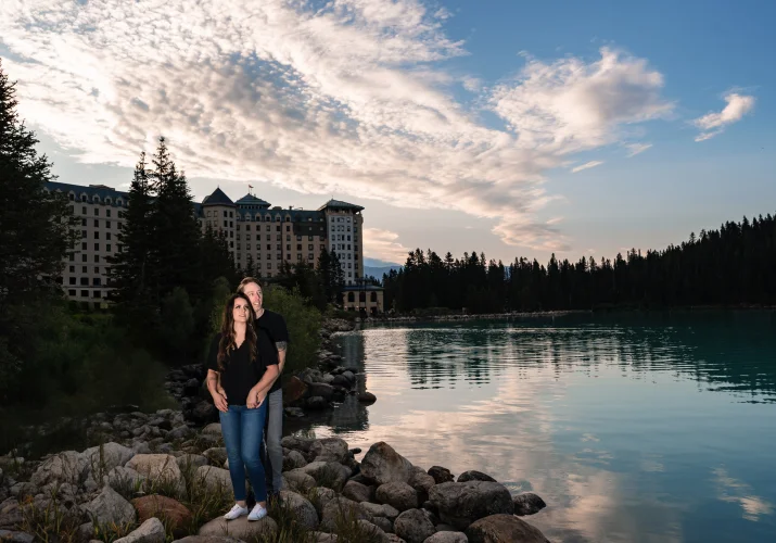 Engaged couple in front of Fairmont Hotel at Lake Louise