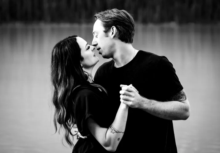 Couple in love hold their n hands and are about to kiss.