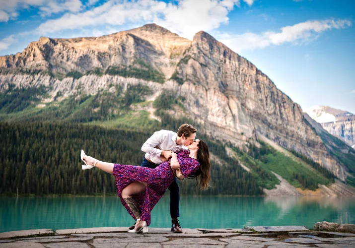 Lake Louise Engagement Photography of a dancing couple against a huge mountain
