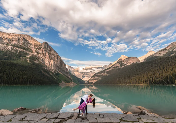 Dancing couple at stunning Lake Luoise against the rocky Mountains