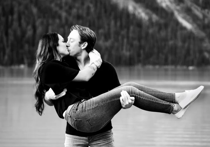 Man carry his fiancee and kiss her