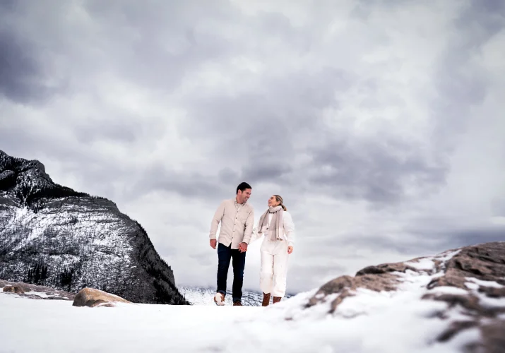 lovers walk during winter against the heavy clouds