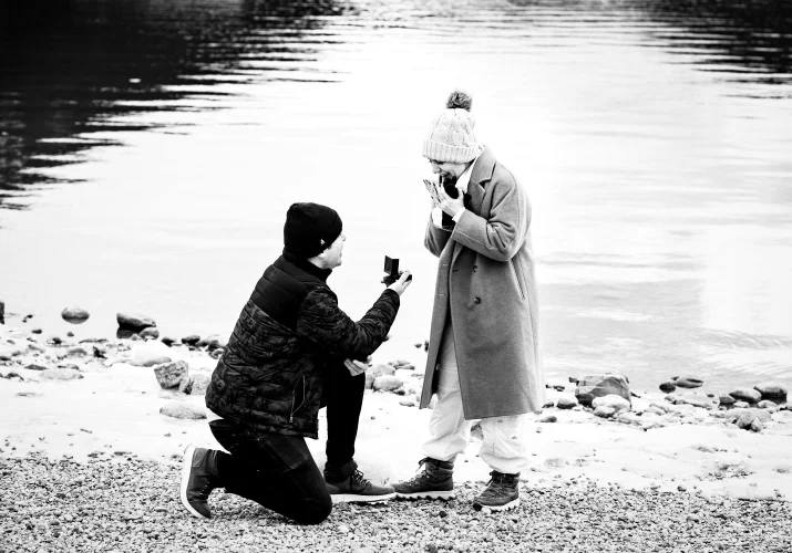 black and white photography of a mad sown the knee proposing with an engagement ring to fis girlfriend