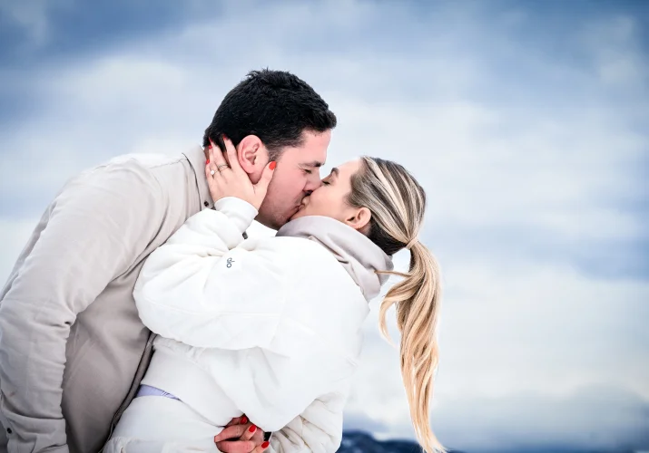 Engaged couple share a romantic kiss