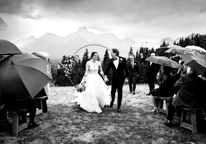 bride and groom walk down the aisle