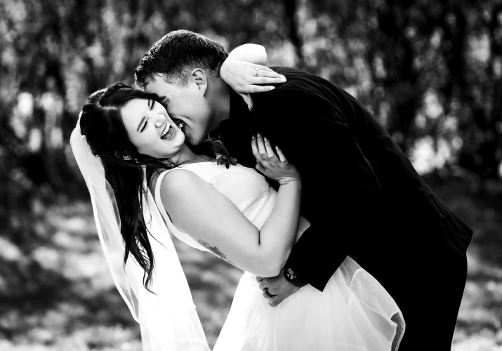 Groom kisses the bride during session in Calgary