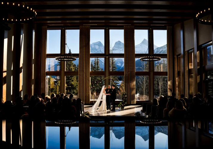 Bride and groom exhcange the vows during wedding ceremony in Canmore