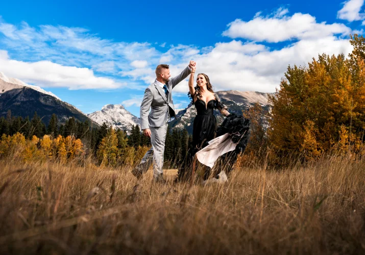 Groom's spinning the bride during portrait session in Canmore