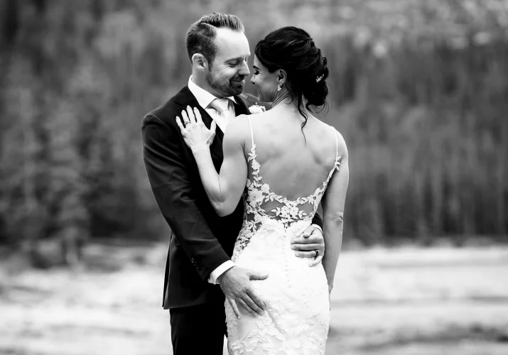 Bride and groom hug during wedding portrait session