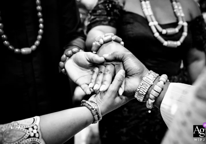 Hands of parents and newlyweds touching during Nigerian Wedding in Calgary.