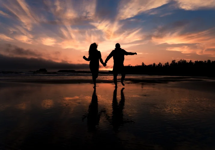 Couple in love is running on the beach in Banff National Park