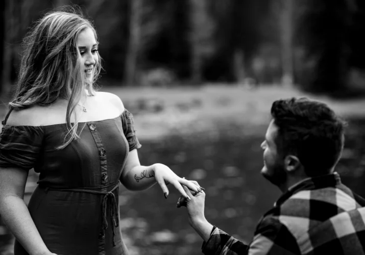 Proposal at Minneawnka Lake. A mad went down on his knee asking his fiancee to marry him.