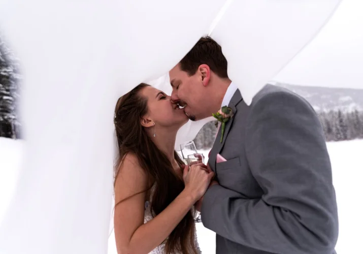 newlyweds kiss under the vail