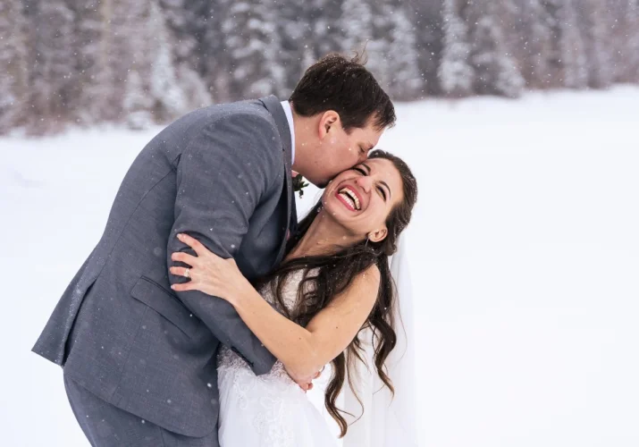 Groom kissing bride's cheek