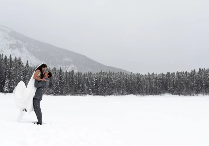 groom lifting the bride during mountain session with Banff Wedding Photographers