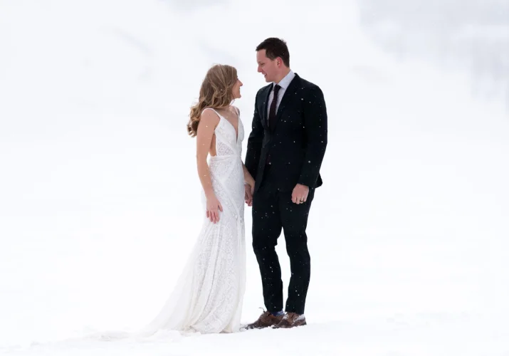 Newlyweds looking at each other during their after wedding photo session at Bow Lake