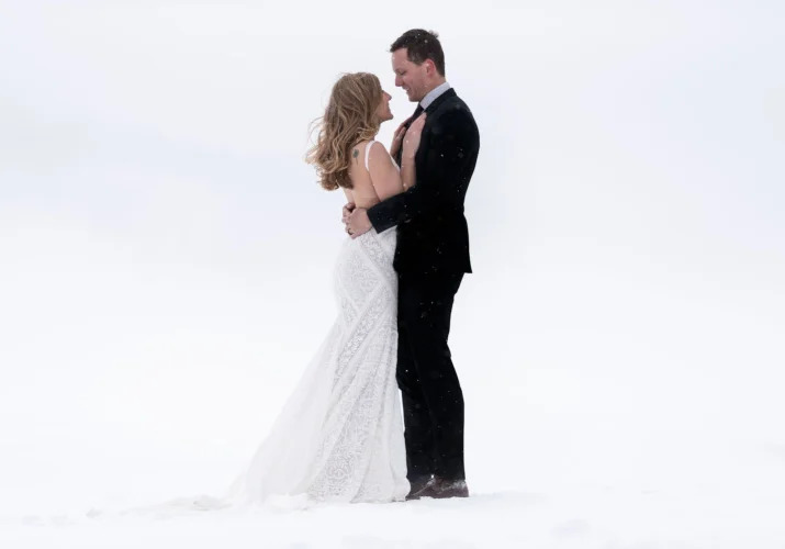 Winter after wedding photo shoot with hugging couple in love.