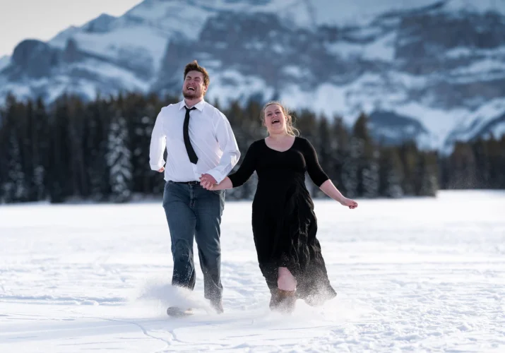 Engaged couple are having fun in the snow.