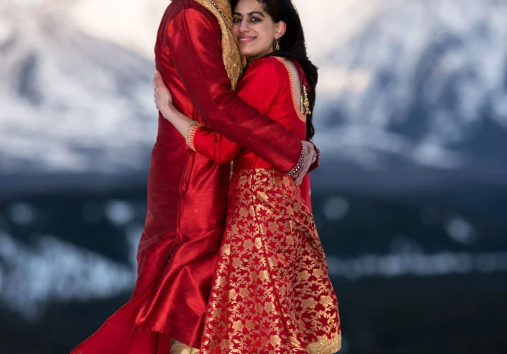 Newlyweds are hugging during their after wedding photo session in Banff.