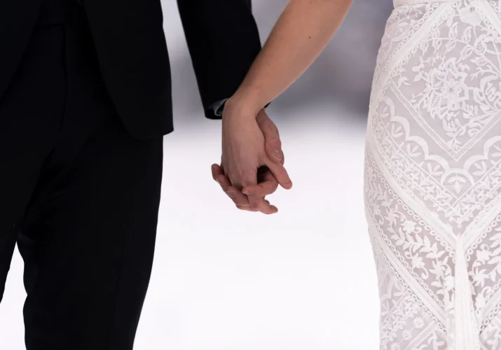 a couple holds hands
