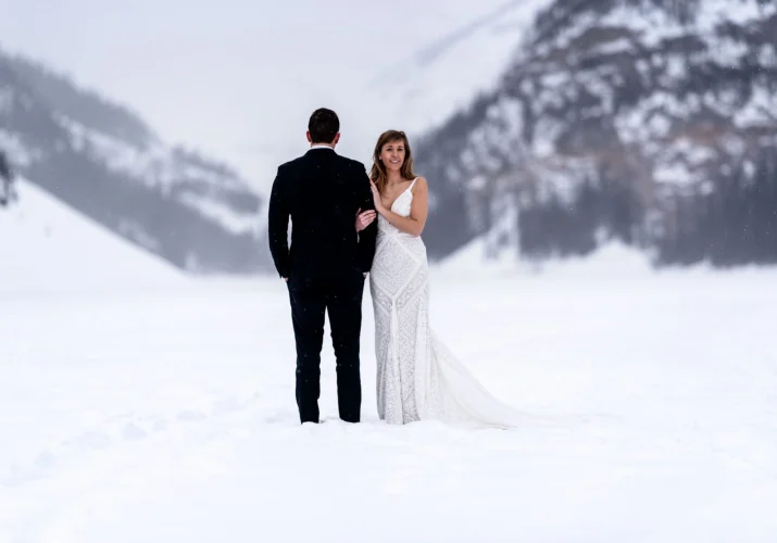 Lake Louise Wedding. Bride is smiling at the camera