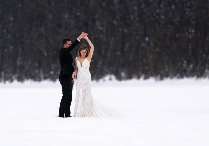 newlyweds are dancing during Banff Winter Photo Session