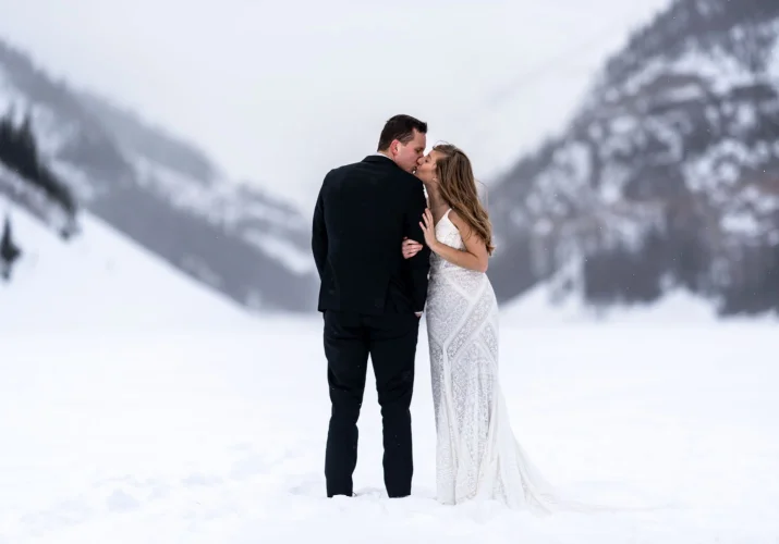 Bride kissing the groom at Lake Louise