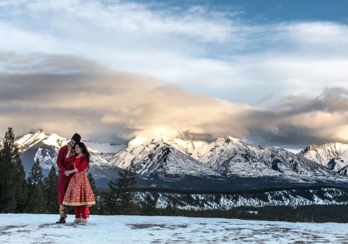 Indian couple looking at the mointains during their photo session in Banff National Park.