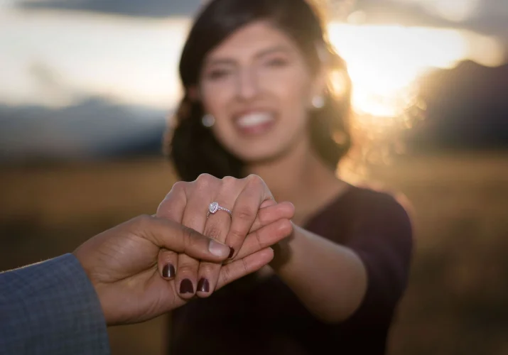 Suprised woman shows her beautiful engagement ring.