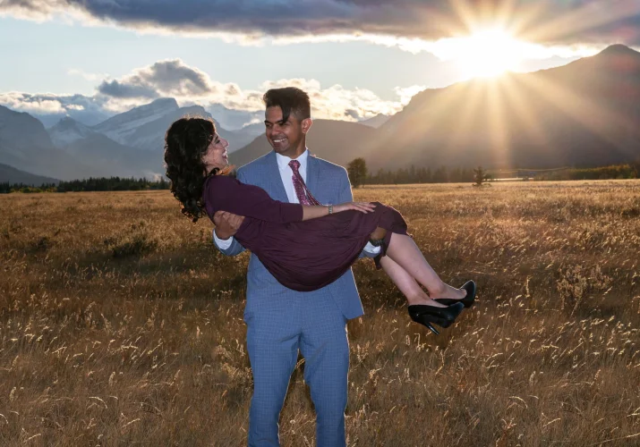 Fall engagement in Banff. A man carry his future wife on hands